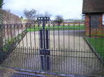 A photo of the ornate iron gates across the drive of the hall