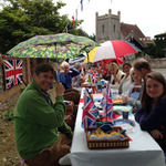 A close up of one end of the table of revelers in front of the church